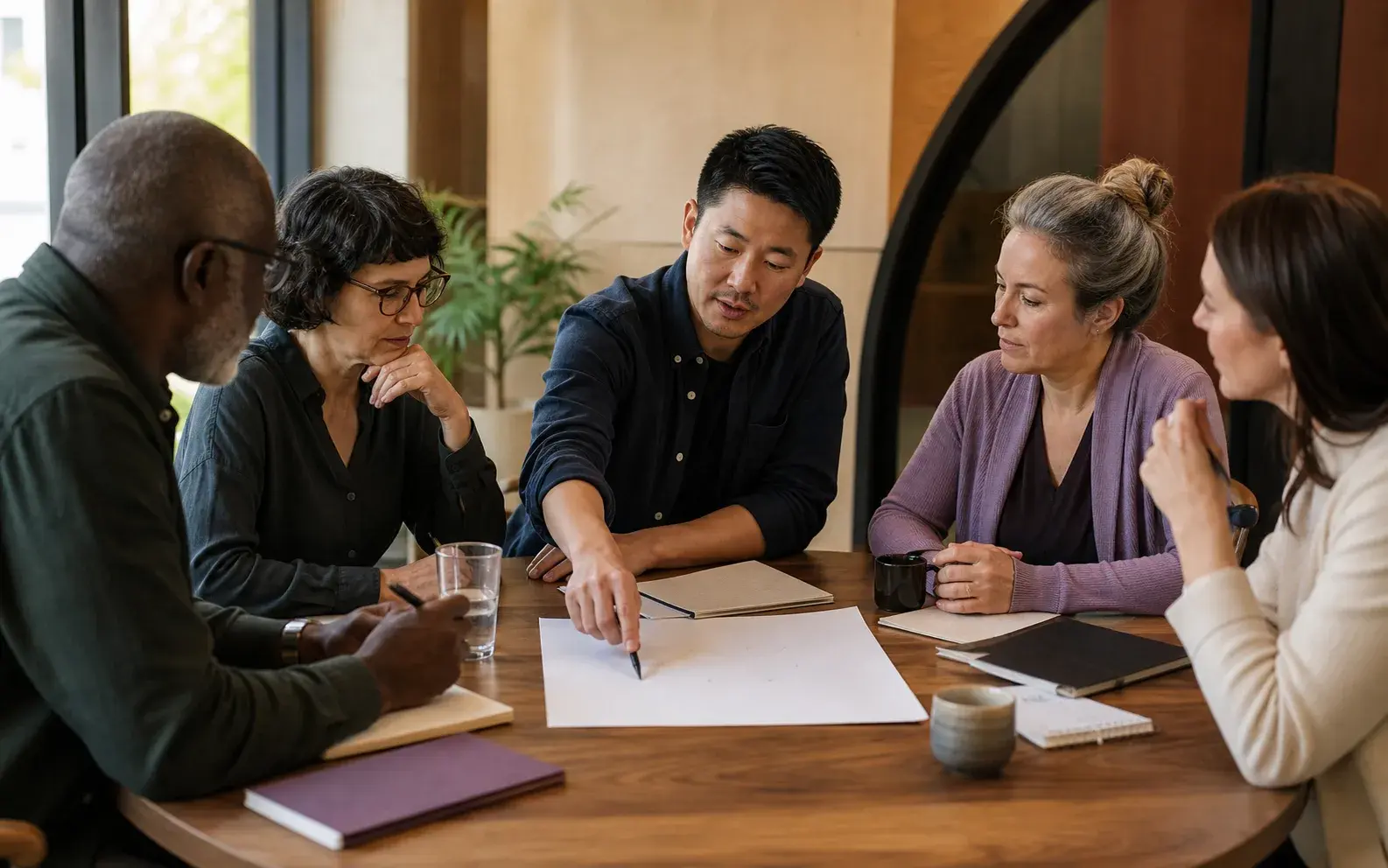 A diverse group of association members works through shared priorities around a table.